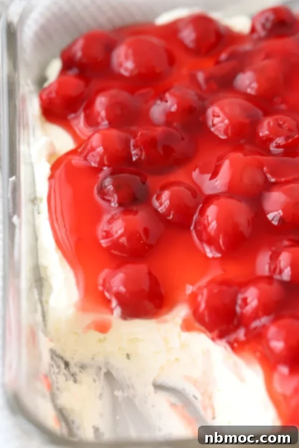 Creamy No-Bake Cherry Cheesecake Dip topped with fresh cherries and adaptable with blueberries for a patriotic dessert.