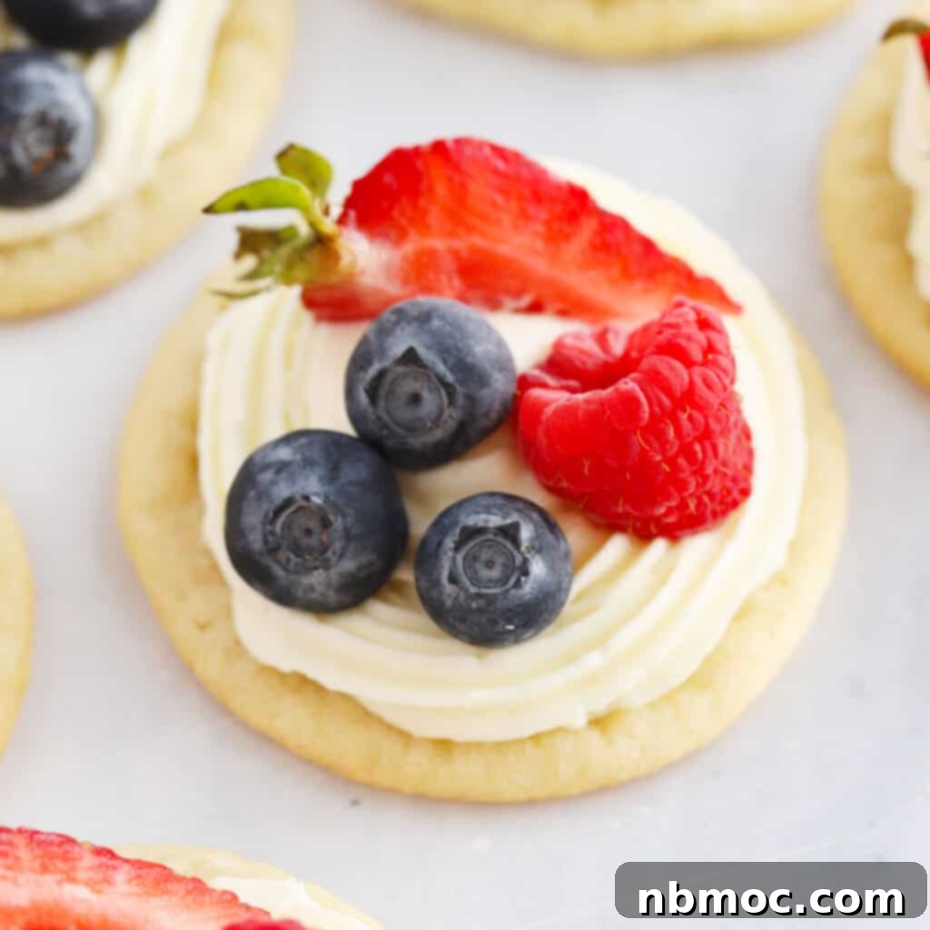 An Easy Sugar Cookie Fruit Pizza decorated with red, white, and blue fruits for a customizable holiday dessert.