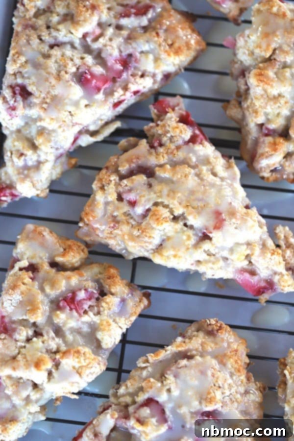 Fluffy Strawberry Scones with a tart lemon icing on a wire rack, perfect for red, white, and blue snacks.