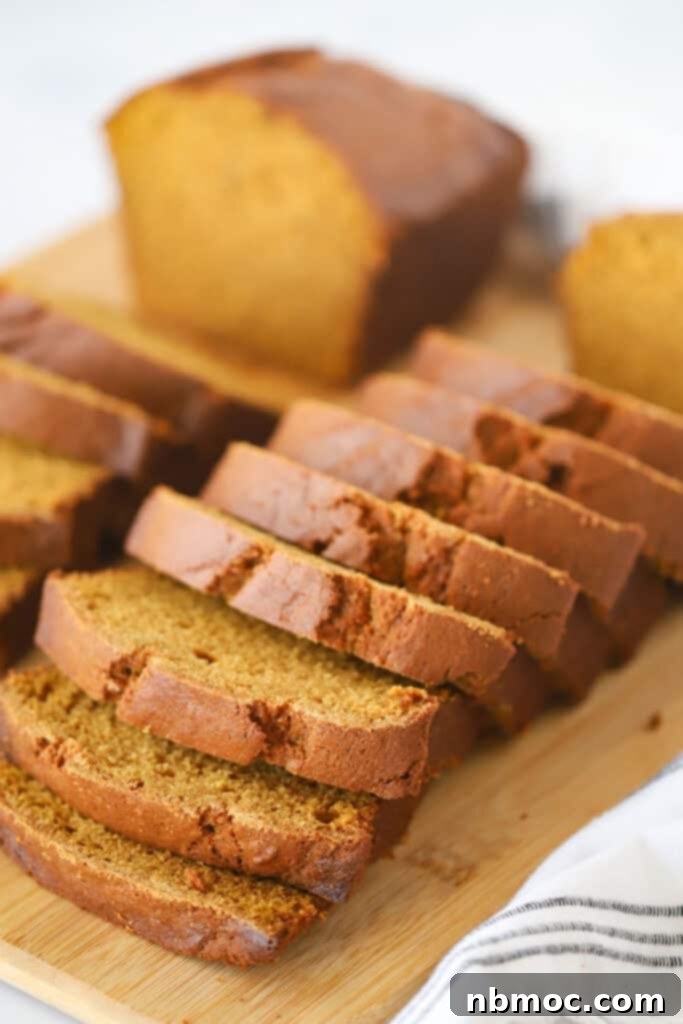Autumn Spice Pumpkin Loaf 2 Sliced loaves of fresh pumpkin bread on a cutting board, ready to be served for a delightful fall treat.