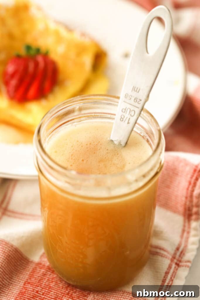 Velvety Buttermilk Syrup Perfection 2 Homemade buttermilk syrup recipe a mason jar on a breakfast table, ready to be served.