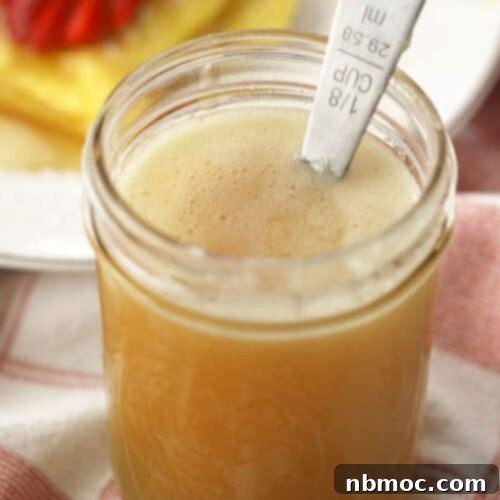 Velvety Buttermilk Syrup Perfection 6 Homemade Buttermilk syrup recipe a mason jar on a breakfast table, glowing golden.