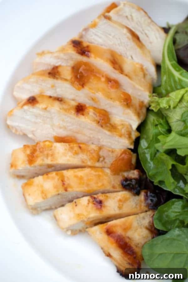 Grilled Apricot Chicken on a white plate with green salad