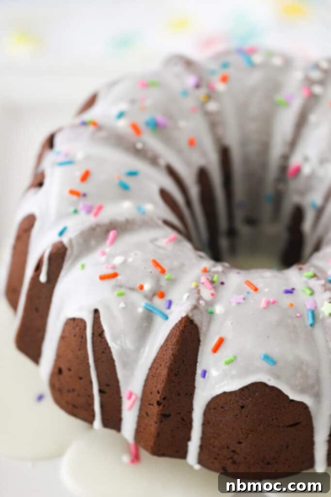 Decadent Chocolate Pound Cake 2 A beautifully baked chocolate cream cheese pound cake in a bundt pan, elegantly topped with a delicate glaze and colorful sprinkles, showcasing the best of chocolate pound cake recipes.