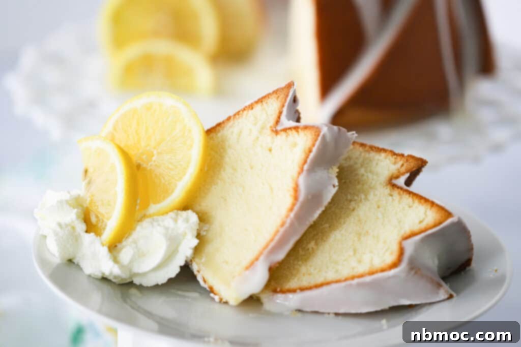 Slices of cream cheese lemon pound cake on a white plate with fresh lemon and whipped cream, ready to be enjoyed.
