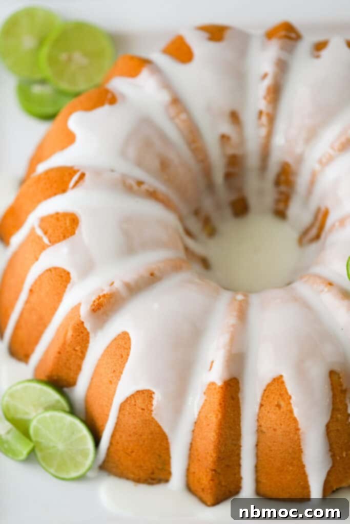 Florida Keys Pound Delight 2 A key lime bundt cake topped with glaze and surrounded by sliced fresh limes.
