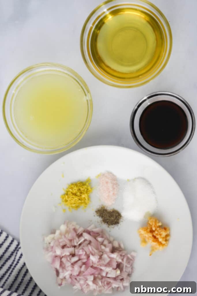 Small ramekins and a plate filled with ingredients to make balsamic dressing for caprese pasta salad.