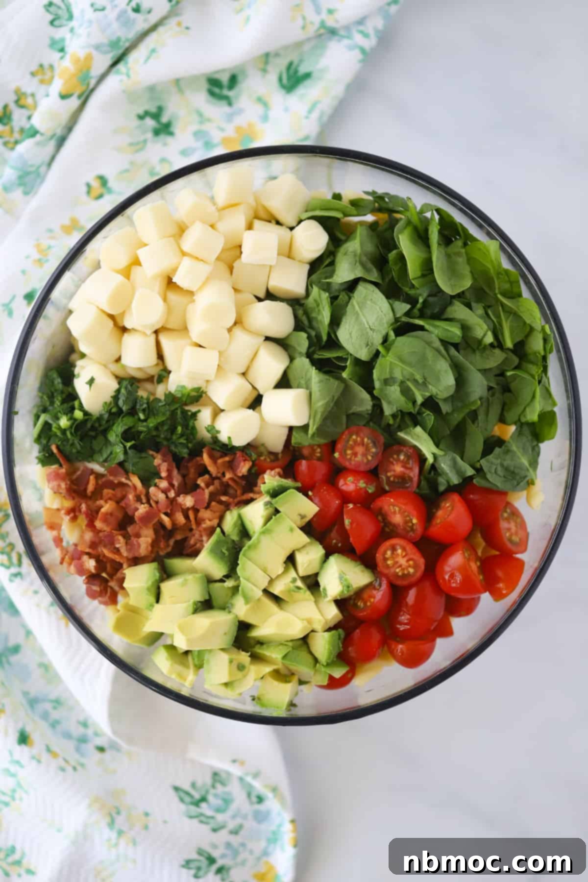 Ultimate BLT Pasta Salad 3 A large glass mixing bowl full of ingredients to make this BLT salad recipe with pasta.