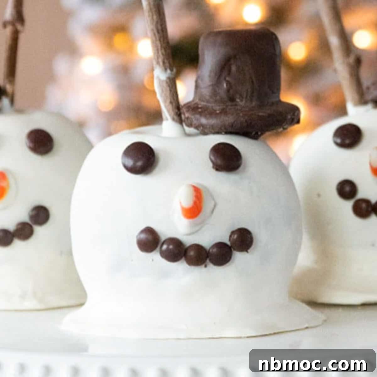 21+ Decadent Caramel Dessert Recipes 16 Charming snowman caramel apples, perfect for festive winter celebrations.