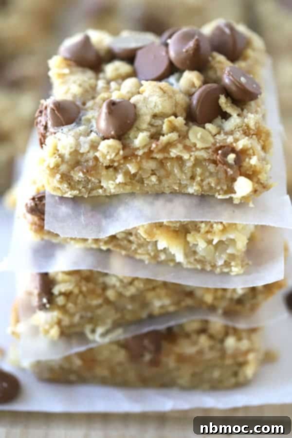 21+ Decadent Caramel Dessert Recipes 22 A delightful stack of magic bars, each separated by small pieces of parchment paper.