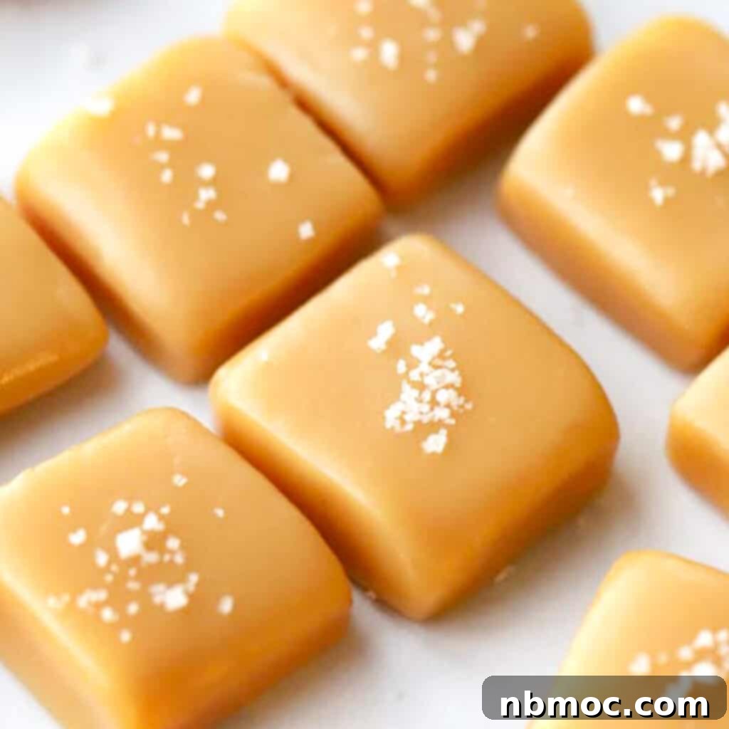 21+ Decadent Caramel Dessert Recipes 7 Homemade caramel candies, neatly cut into squares and sprinkled with sea salt, arranged on parchment paper.