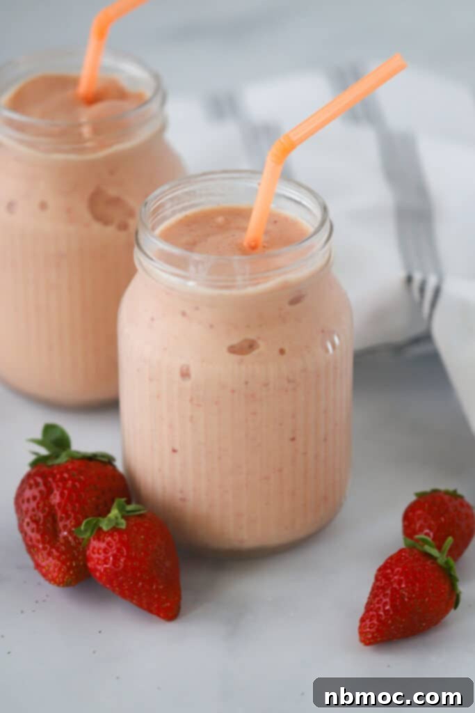 Creamy Citrus Berry Swirl 5 Glasses with straws filled with strawberry orange smoothie.