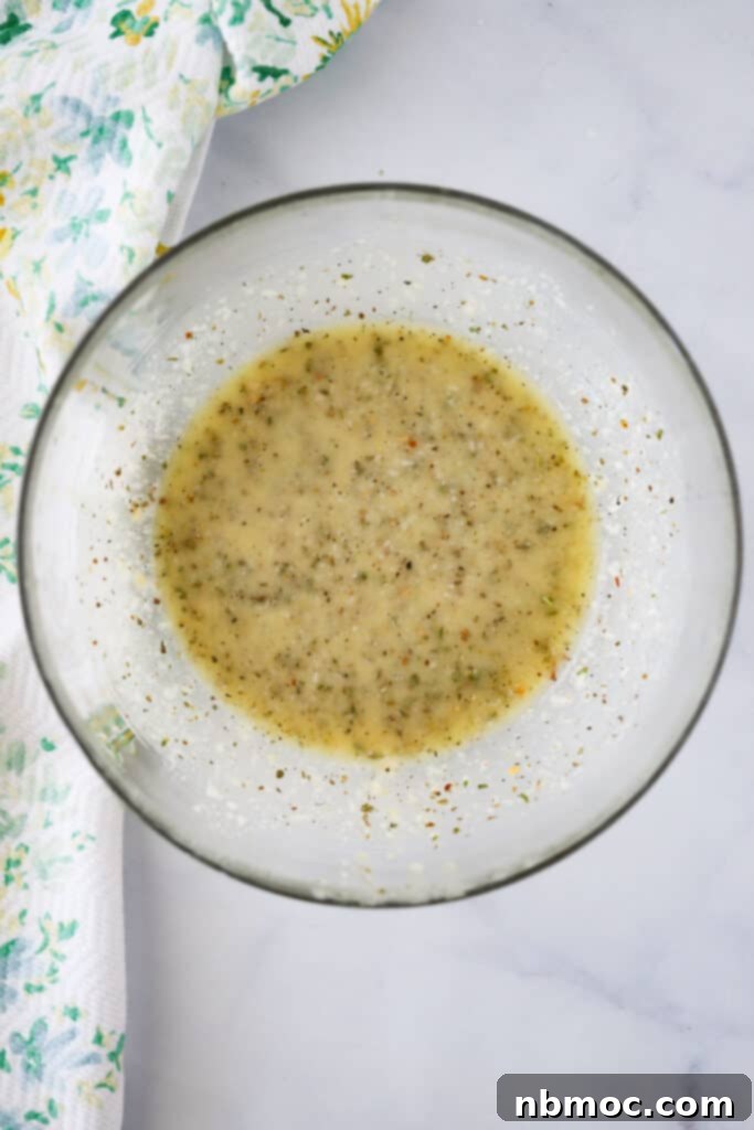 Zesty Italian Vinaigrette 2 A large glass bowl filled with a rich, creamy homemade Italian dressing, ready to be served or stored.