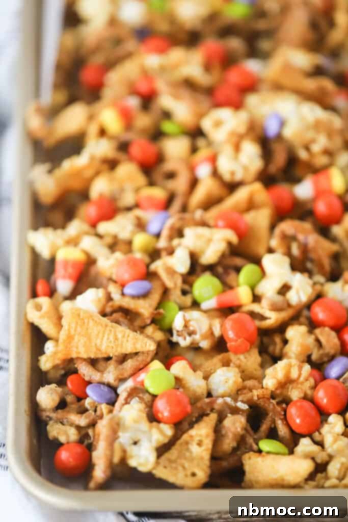 A baking tray full of our Halloween snack mix, including Bugles, candy corn, popcorn, and M&Ms, ready to be enjoyed.