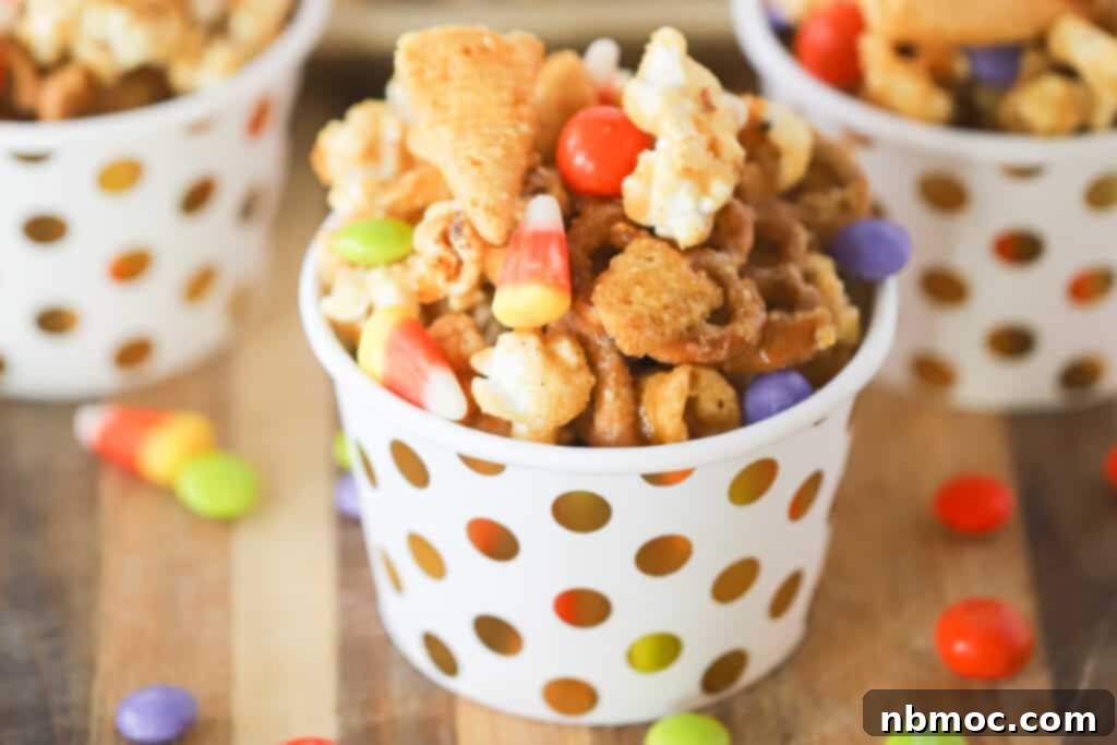 Small individual decorative cups full of Sweet Fall snack mix, showcasing festive presentation.