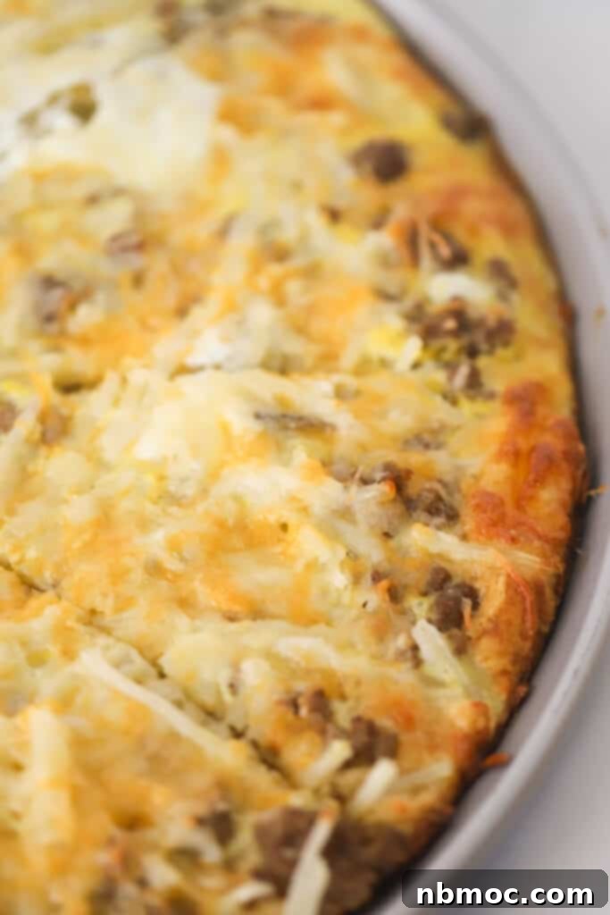 A Golden Brown Crescent Roll Breakfast Pizza on a pizza pan, perfectly cut into eight slices, showcasing its hearty toppings.