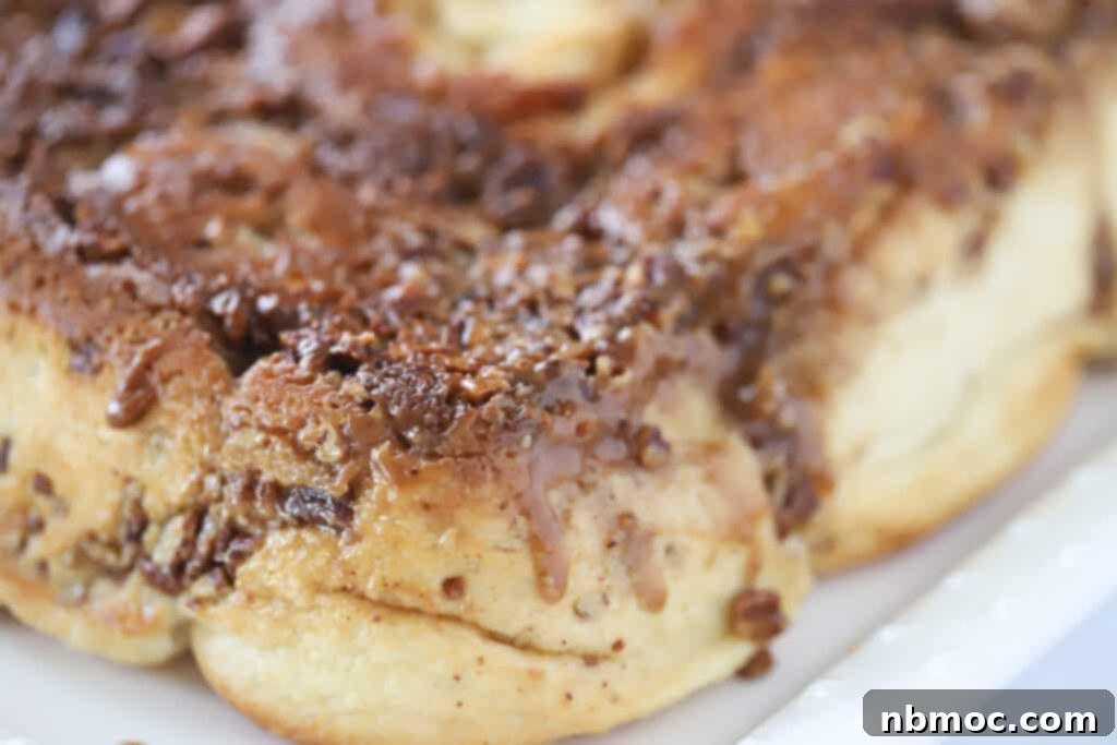 Gooey Caramel Delights 6 A white serving platter showcasing an abundance of glistening pecan sticky buns.