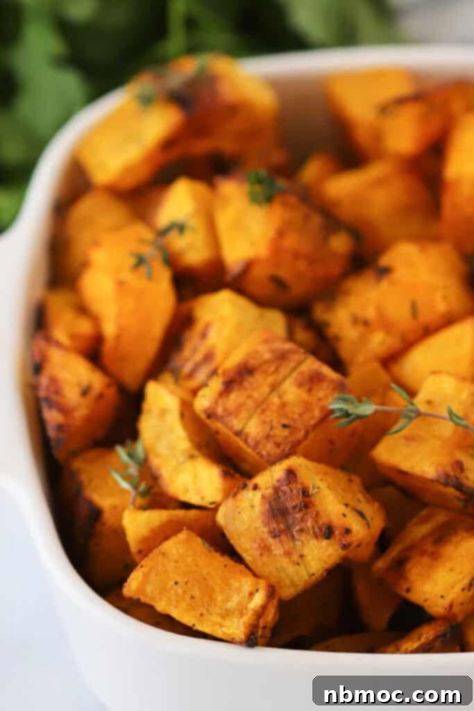 Golden Roasted Squash 2 A white serving dish full of golden brown Oven Roasted Squash, cut into perfect cubes.