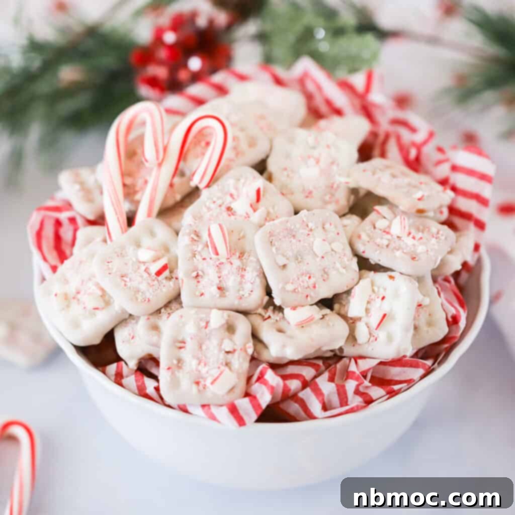 Mint Kissed Pretzel Crunch 3 Close-up of a white chocolate dipped pretzel with crushed candy canes.