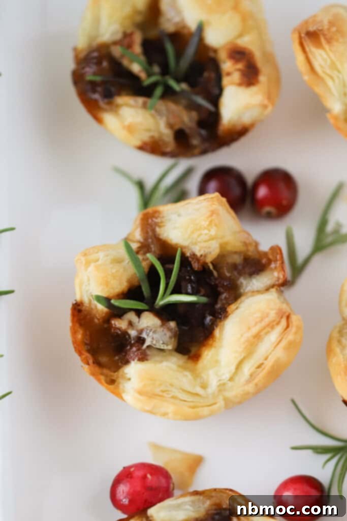 Baked brie bites made with phyllo dough, cranberry sauce, and fresh rosemary.