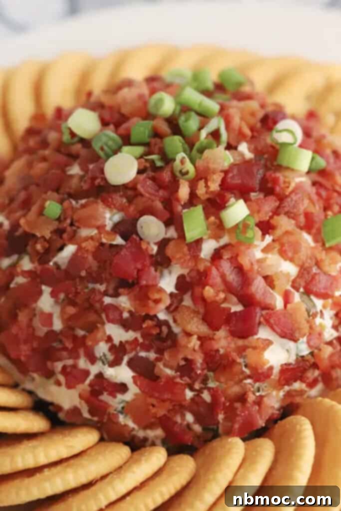 A festive Bacon Ranch Cheese Ball surrounded by golden Ritz crackers, ready for serving at a party or holiday gathering.