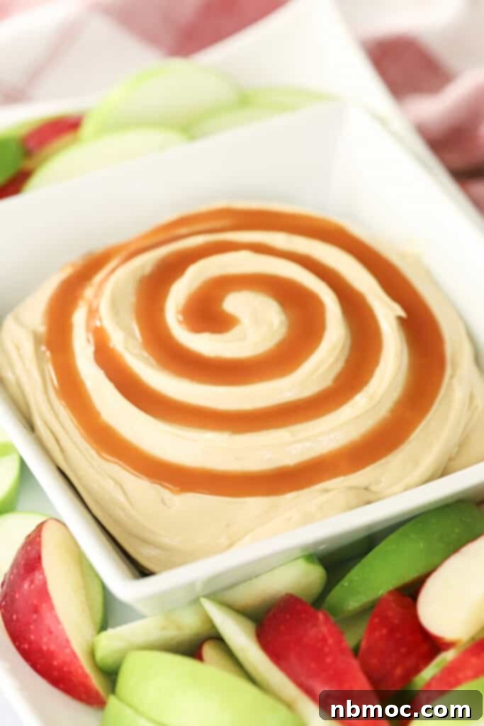 Caramel Apple Cream Cheese Delight 2 A bowl full of cream cheese caramel apple dip surrounded by apple slices.
