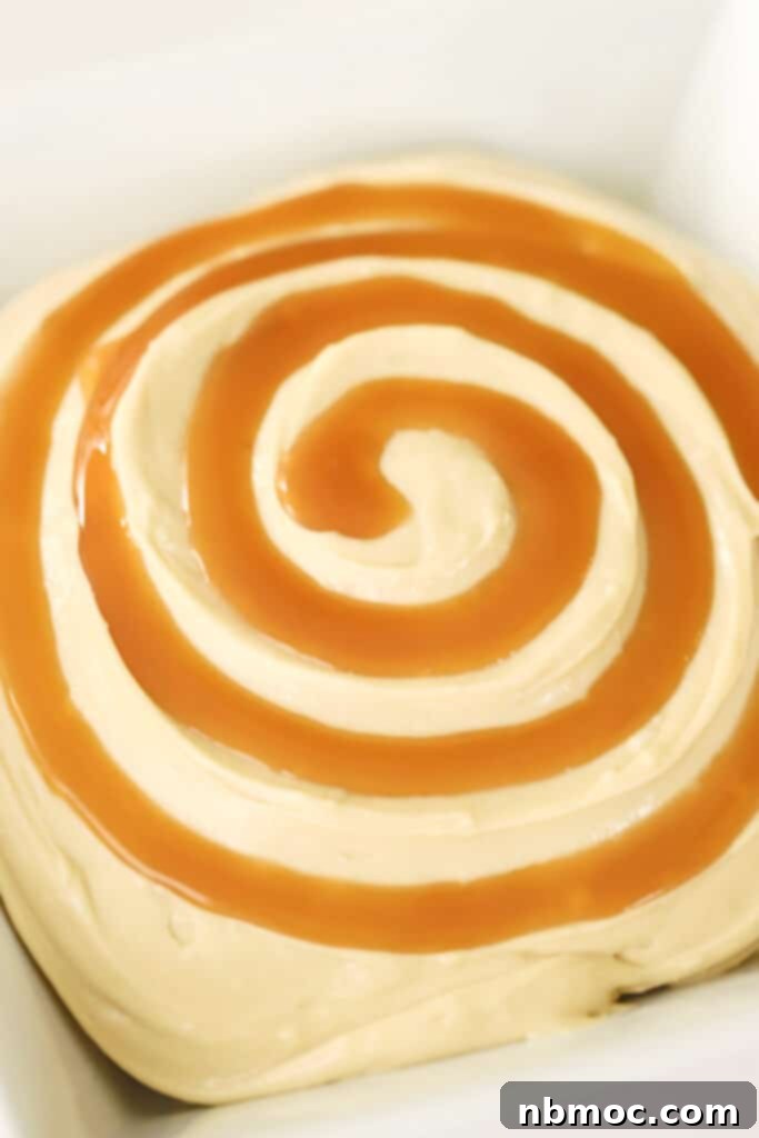 Caramel Apple Cream Cheese Delight 4 A bowl full of cream cheese apple dip with a spiral of caramel sauce over the top.
