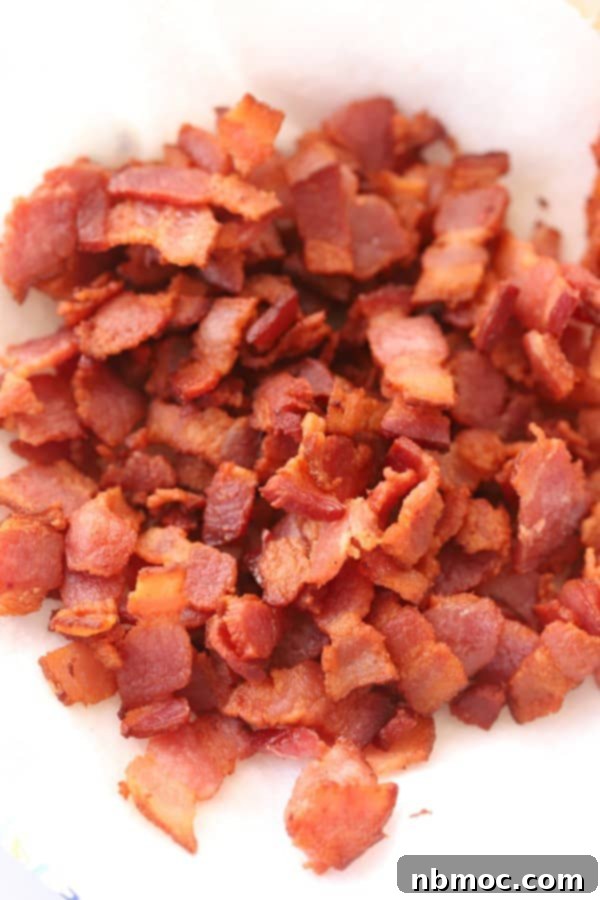 A bowl full of homemade bacon bits. best bacon bits recipe; recipes with bacon bits. Bacon bit, bacon bit recipes, bacon pieces.