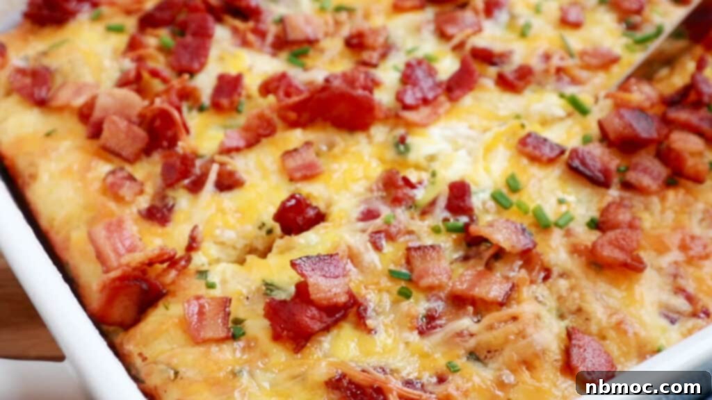 A tater tot breakfast casserole made with eggs and bacon bits. bacon bits on top of casserole. recipe with bacon bits. 
