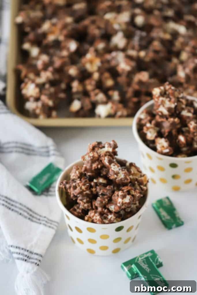 Small decorative cups full of Andes Chocolate Mint Popcorn, an easy recipe for peppermint popcorn.