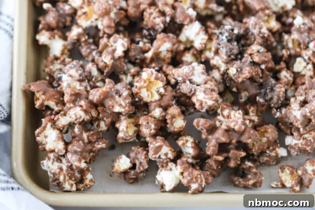 A baking sheet covered in Andes Mint Chocolate Popcorn, a great Christmas popcorn idea.