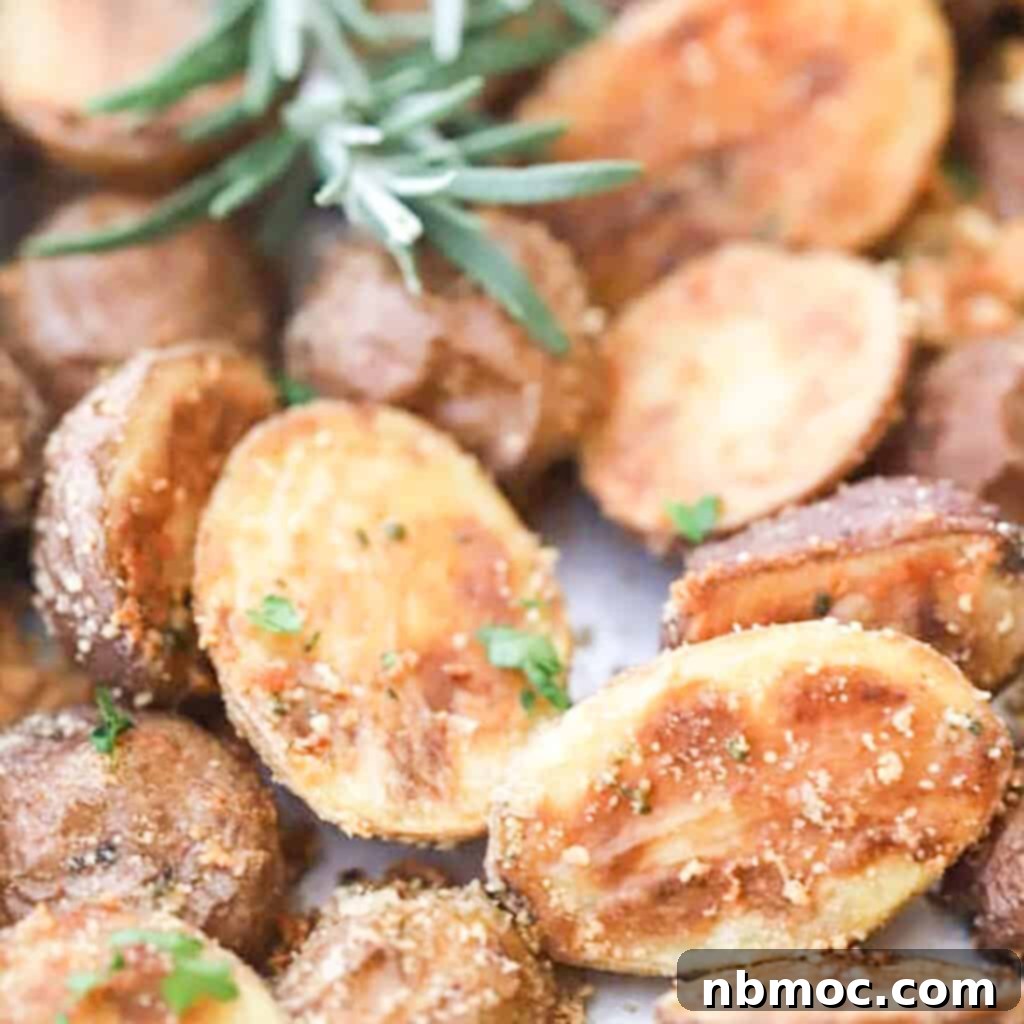 Valentines Day Dinner Inspiration 15 Golden Rosemary and Parmesan Fingerling Potatoes baking on a sheet pan, an ideal and flavorful side dish for any Valentine's Day dinner.