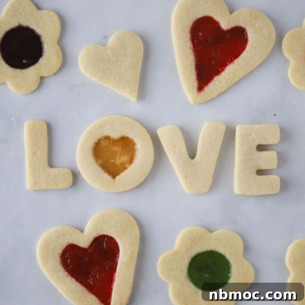 Valentines Day Dinner Inspiration 23 Intricate Stained Glass Cookies, showcasing vibrant melted hard candy centers, a charming and beautiful dessert for Valentine's Day.