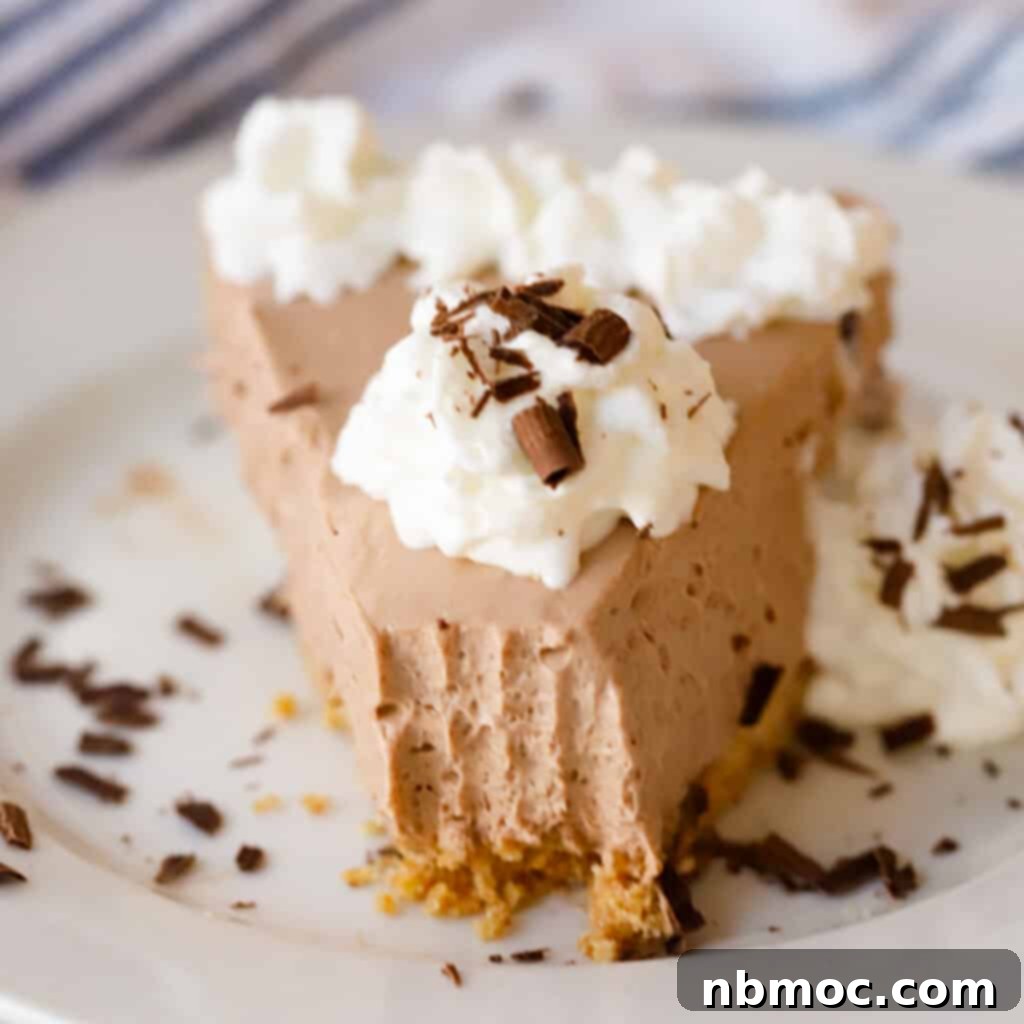 Valentines Day Dinner Inspiration 26 A pristine slice of No-Bake Chocolate Cheesecake, elegantly topped with fluffy whipped cream and delicate chocolate shavings, a perfect Valentine's dessert.