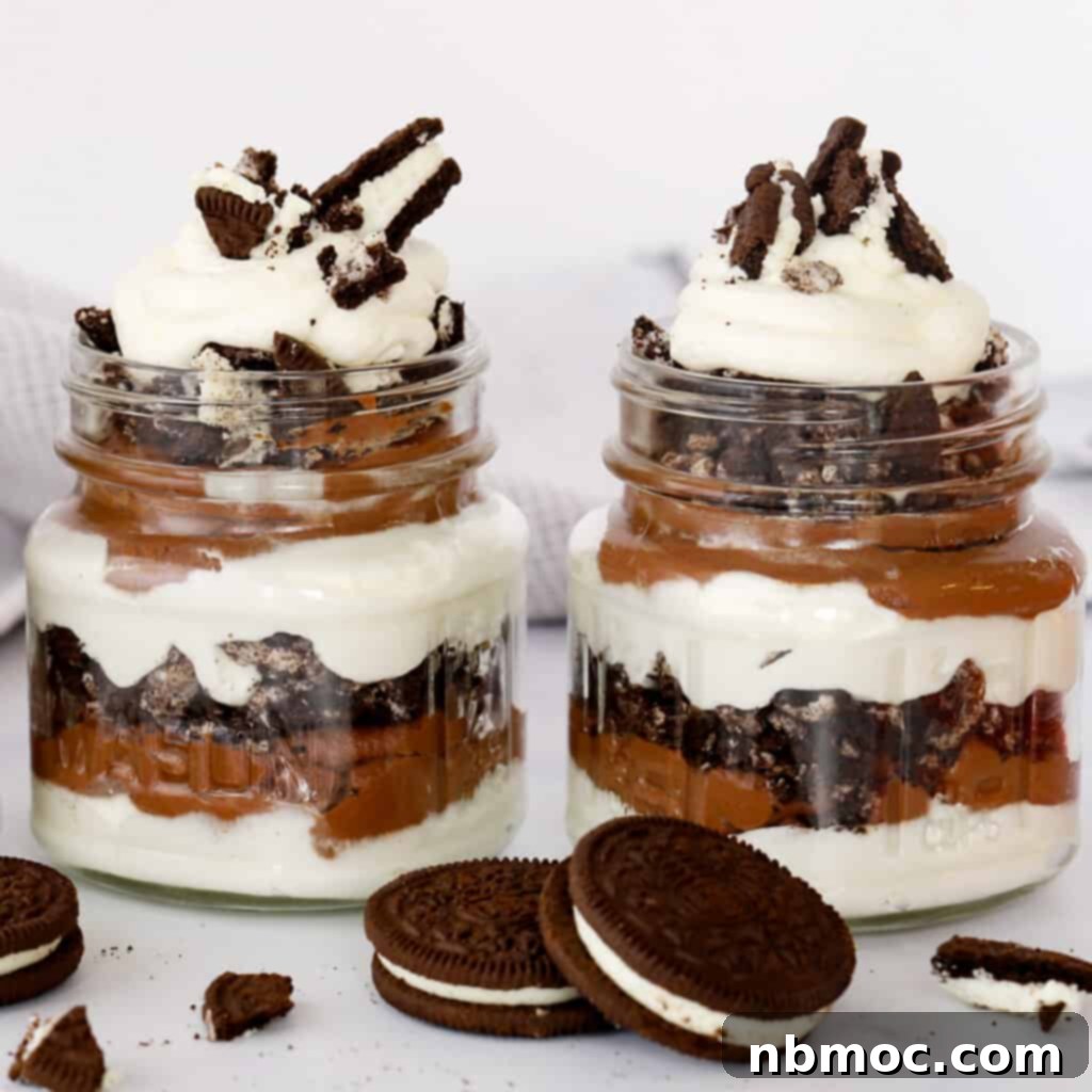 Valentines Day Dinner Inspiration 28 Individual Chocolate Oreo Parfaits presented in elegant glass jars, topped with whipped cream and crushed Oreos, a simple yet impressive dessert.