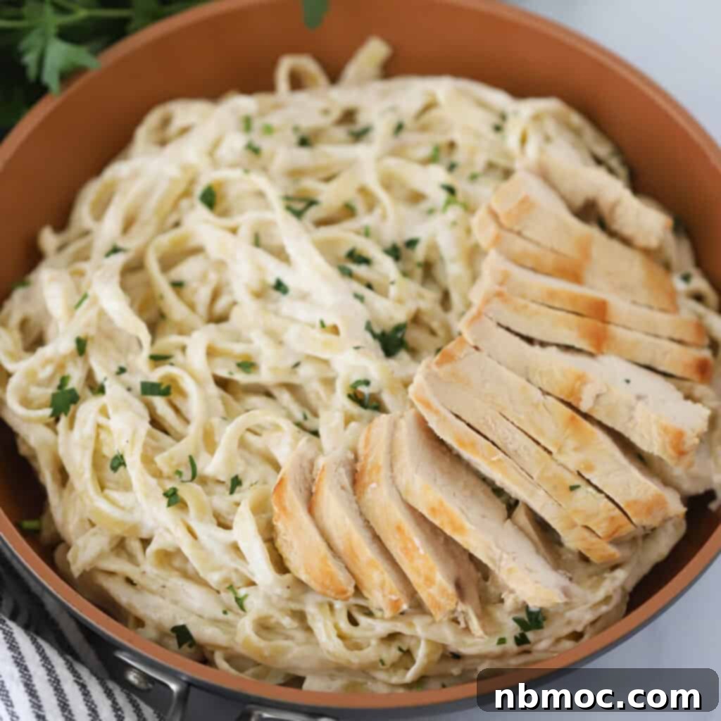Valentines Day Dinner Inspiration 4 A large bowl of creamy Chicken Fettuccini Alfredo, a comforting and delicious Valentine's meal idea for two or a family.