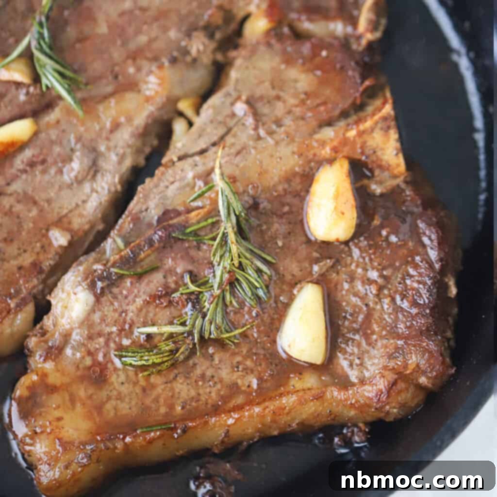 Valentines Day Dinner Inspiration 8 A sizzling cast iron skillet presenting a perfectly Pan Seared Steak, richly seasoned with garlic and rosemary, ideal for a romantic or family Valentine dinner.