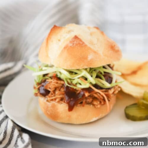 Pulled BBQ chicken breast made in a slow cooker, juicy and perfect for sandwiches or other meals.
