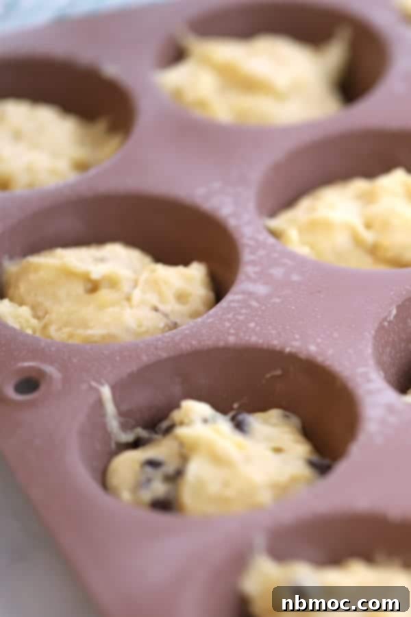 Nourishing Banana Muffins 4 Banana Greek yogurt muffin batter in a tin, ready for baking – an easy and healthy banana muffin recipe.