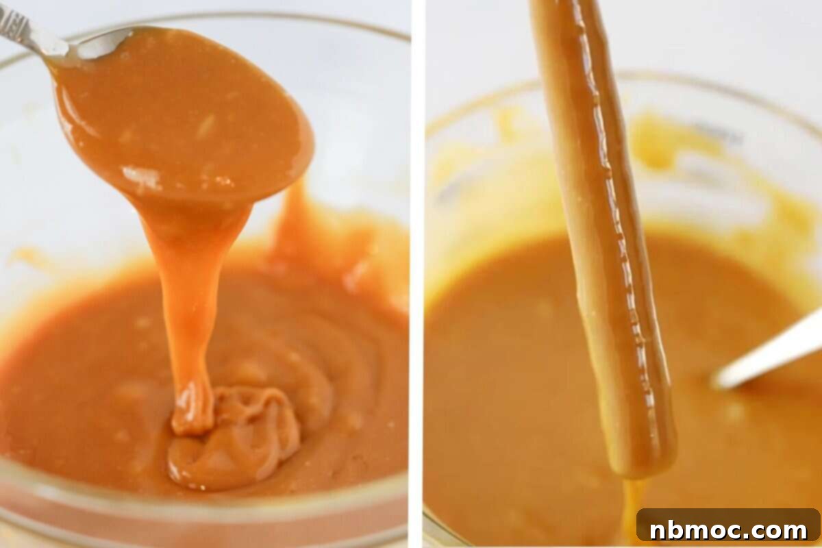 pretzel rod being dipped in a large bowl of caramel sauce.