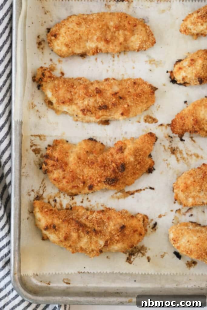 Crispy Golden Chicken Strips 5 A sheet tray full of oven-baked Chicken Tenders. Oven fried chicken tenders, how to cook chicken tenders in the oven, oven baked chicken tenderloins, baked chicken strips recipe, baked chicken tenders recipes.