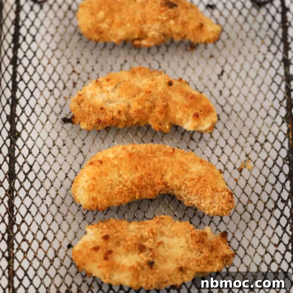 Extra crispy Air Fryer Chicken Tenders inside an air fryer basket.