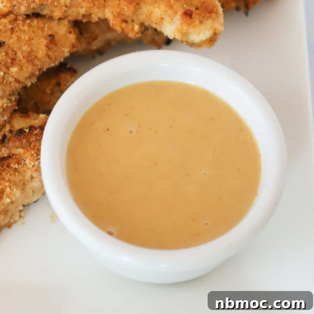 Honey mustard dipping sauce recipe in a white ramekin. the best recipe for honey mustard dipping sauce.