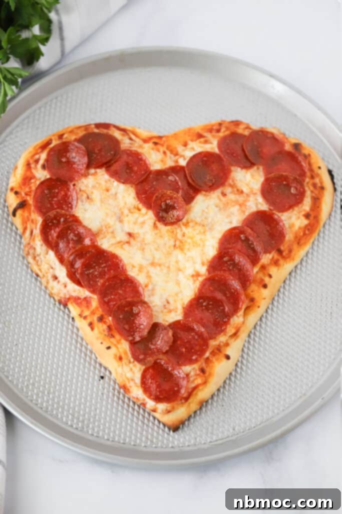 Heartwarming Pizza 2 A Heart Shaped Pizza on a pizza pan with a ring of pepperonis around the edge. How to make a heart shaped pizza. Pizza heart.