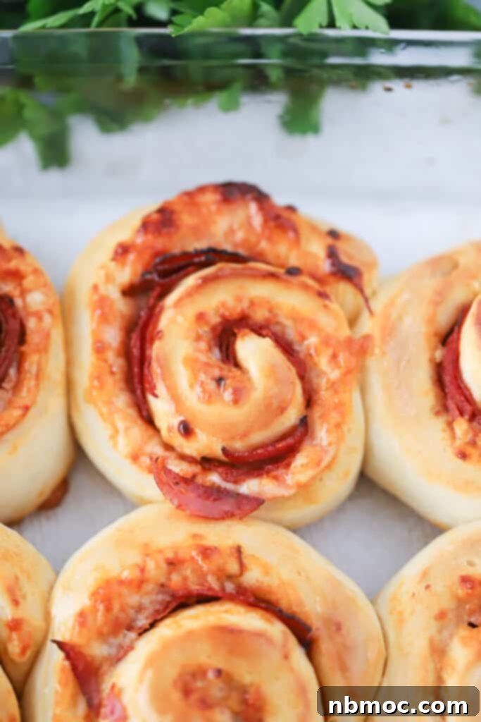 Cheesy Pizza Pinwheels 2 Pepperoni Pizza Roll Ups in a baking dish. Pizza rolls. Roll up pizza.