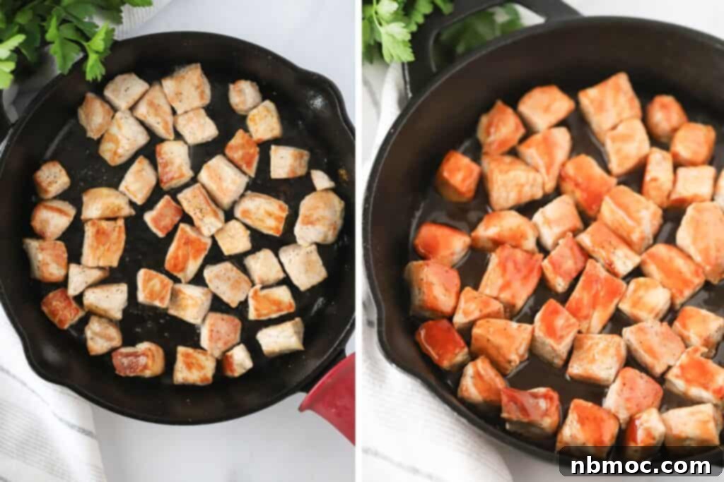 Buffalo Pork Poppers 4 Cooked pork chop bites in a cast iron skillet, covered in buffalo sauce.