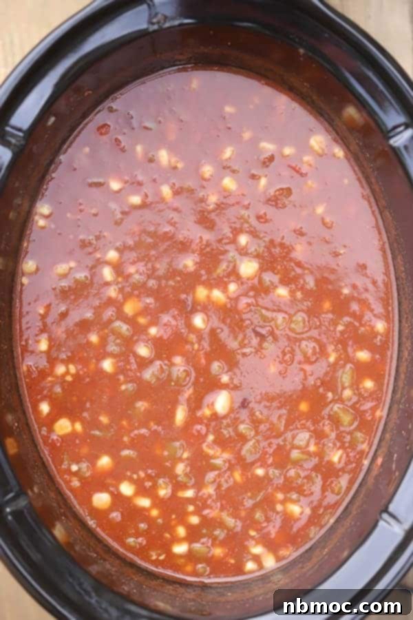 Zesty Black Bean Fiesta Soup 3 A slow cooker filled with vibrant Southwestern black bean and corn soup, simmering to perfection.