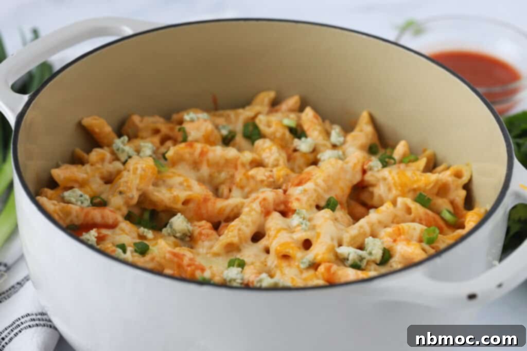 Fiery Buffalo Chicken Pasta 7 A full Dutch oven of creamy Buffalo Chicken Pasta, ready to be served, showcasing the rich texture and vibrant colors.