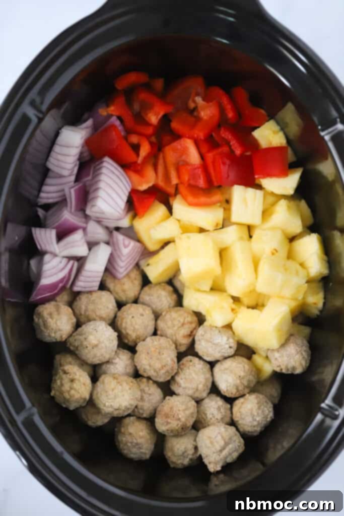 Ingredients for sweet and sour meatballs in crockpot including onions, pineapples, and red peppers. sweet and sour meatballs in crock pot. 