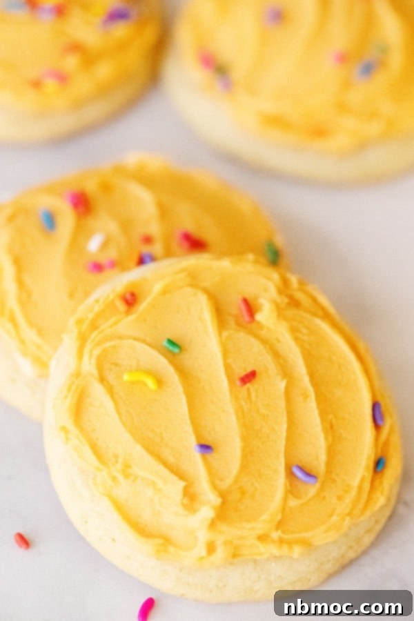 Close-up of freshly baked orange creamsicle cookies with bright orange frosting, showcasing the perfect texture and vibrant color.